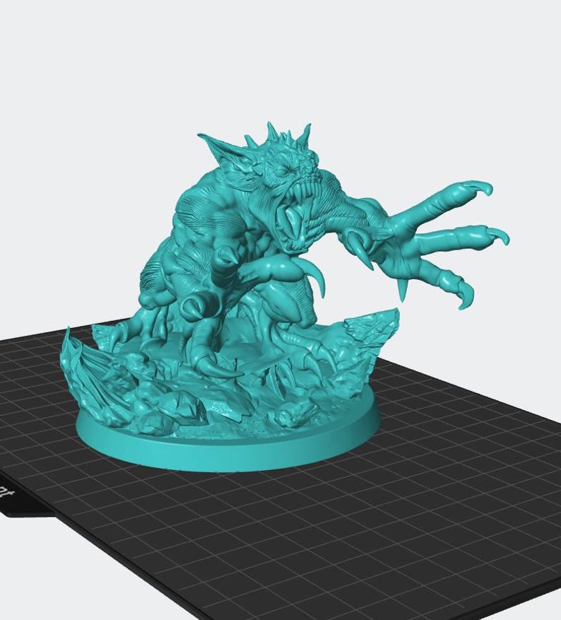 May include: A teal-colored monster figurine with sharp claws, teeth, and horns. The creature is posed on a rocky base, with a round platform. The monster has a menacing expression and is sculpted with detailed musculature.