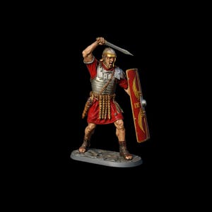 May include: A miniature Roman soldier figurine in a dynamic pose, wielding a sword and shield. The figure is clad in a red tunic, silver armor, and a golden helmet. The shield is red with gold accents and the number IX.