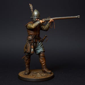May include: A detailed miniature figure of a soldier from a historical period, aiming a long rifle. The figure is dressed in a metal helmet, brown leather jacket, blue trousers, and brown boots. A replica of a historical military figure.