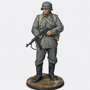 May include: A detailed figurine of a soldier in a grey uniform, helmet, and boots, holding a black rifle. The figure stands on a circular base with a textured surface, showcasing a historical military theme.