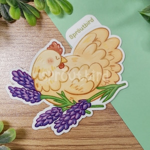 May include: A yellow chicken with closed eyes is nestled in a bed of purple lavender flowers. The sticker has the text "Sproutbird" in the top right corner.