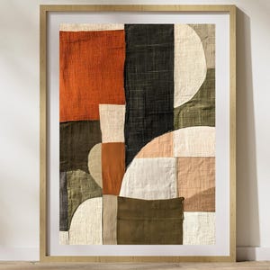 May include: Abstract art print featuring a geometric design with various shades of green, brown, orange, and white. The print is framed in a natural wood frame.