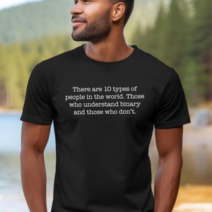 May include: A black t-shirt with white text that reads "There are 10 types of people in the world. Those who understand binary and those who don't."