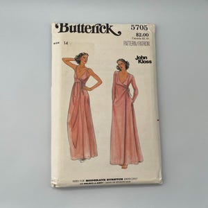 May include: Vintage Butterick sewing pattern 5705, size 14, featuring illustrations of wrap dresses. The pattern includes the designer's name, John Kloss, and the text "SIZED FOR MODERATE STRETCH KNITS ONLY".