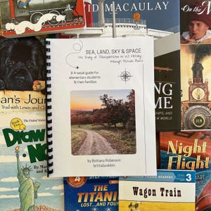 May include: A 4-week guide for elementary students and their families on the history of transportation in the United States through picture books. The cover features a photo of a dirt road leading through a forest with fall foliage.