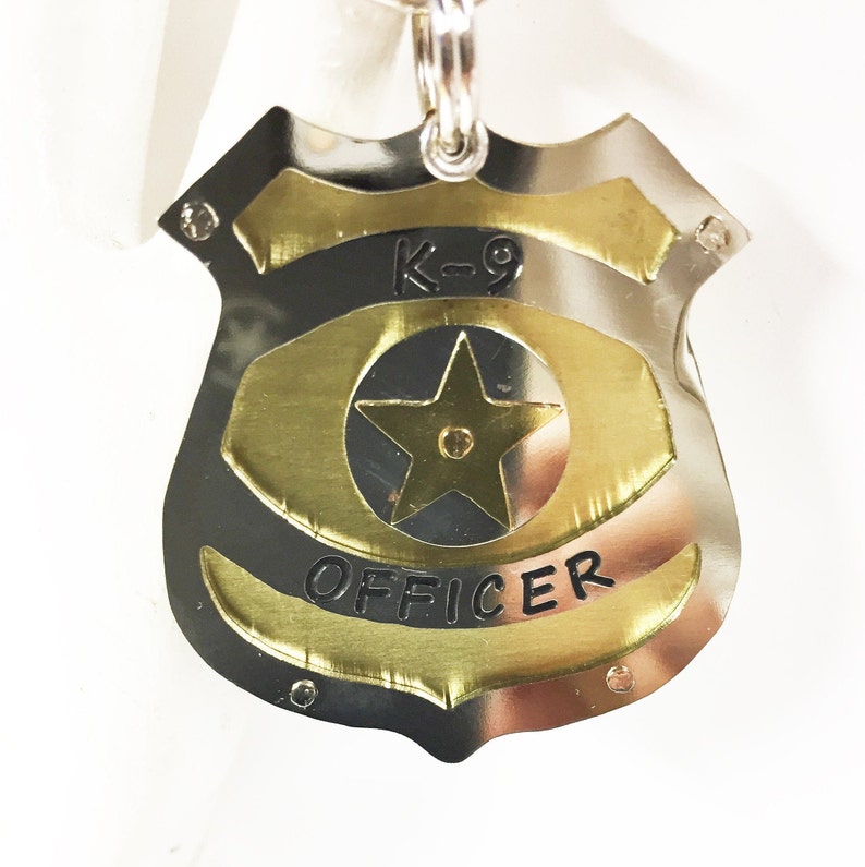 Unique Police Badge pet tag. Custom engraved metal dog law enforcement collar tag. Personalized pet id in nickel silver and brass. All hand cut, riveted and engraved in 5 sizes