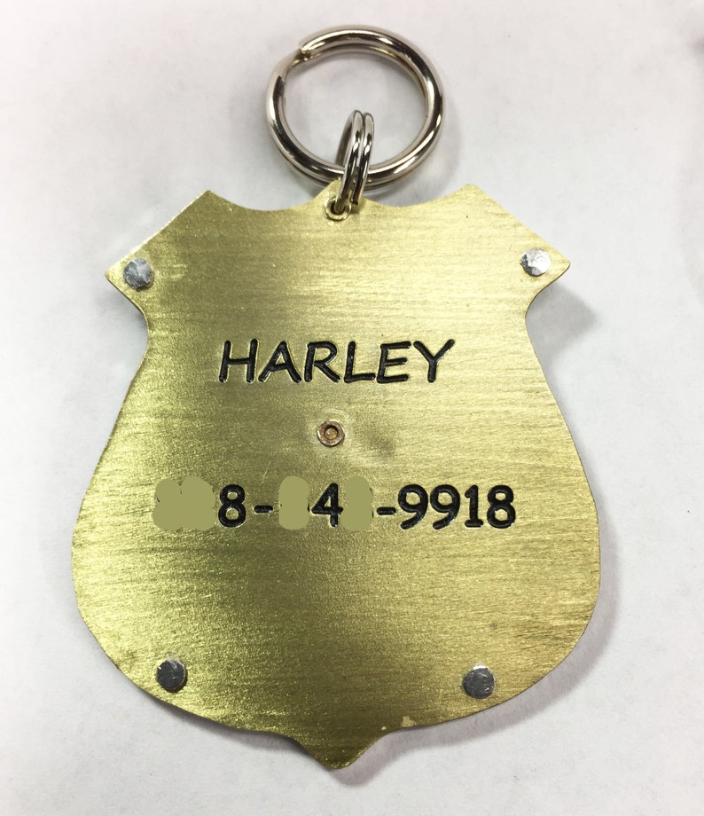 Unique Police Badge pet tag. Custom engraved metal dog law enforcement collar tag. Personalized pet id in nickel silver and brass. All hand cut, riveted and engraved in 5 sizes