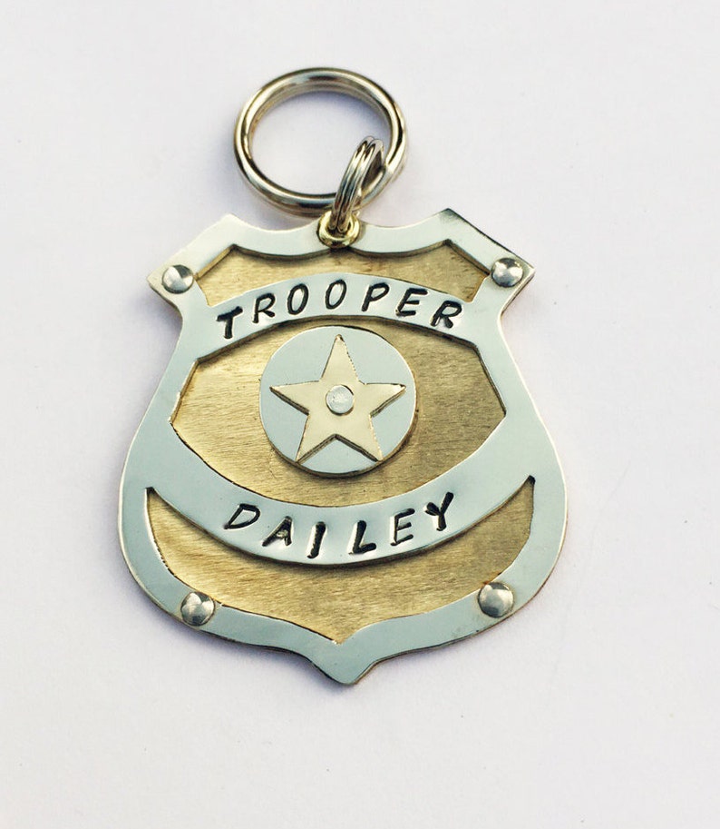 Unique Police Badge pet tag. Custom engraved metal dog law enforcement collar tag. Personalized pet id in nickel silver and brass. All hand cut, riveted and engraved in 5 sizes
