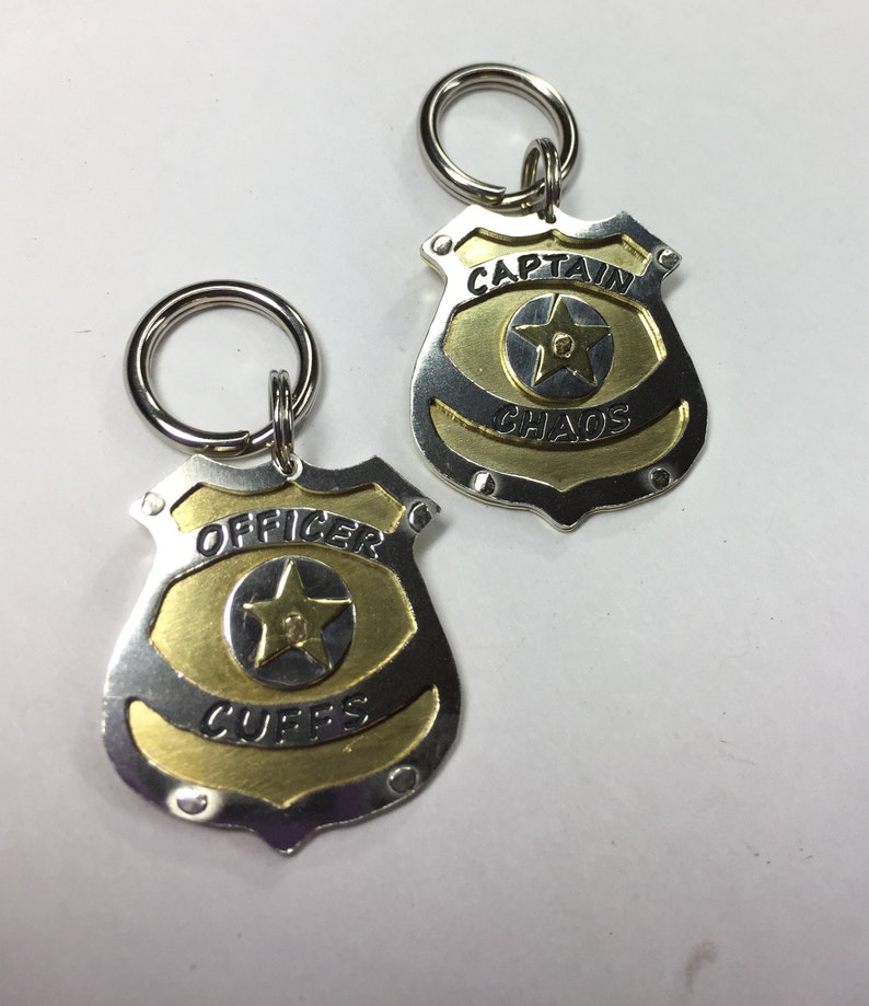 Unique Police Badge pet tag. Custom engraved metal dog law enforcement collar tag. Personalized pet id in nickel silver and brass. All hand cut, riveted and engraved in 5 sizes