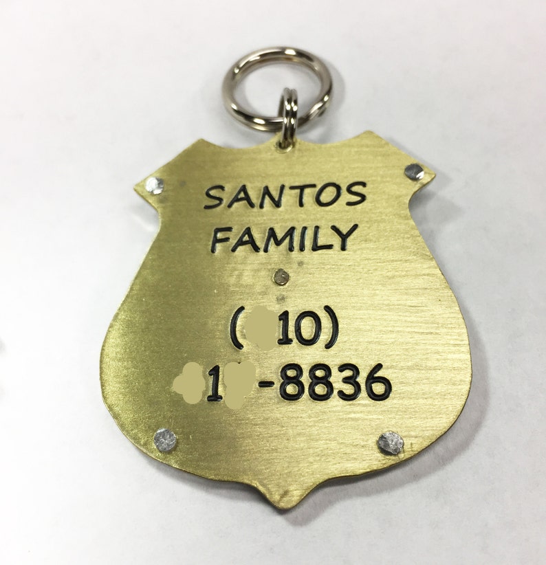 Unique Police Badge pet tag. Custom engraved metal dog law enforcement collar tag. Personalized pet id in nickel silver and brass. All hand cut, riveted and engraved in 5 sizes