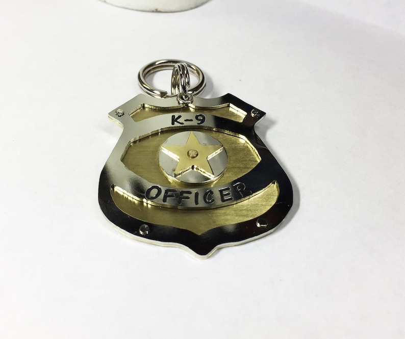 Unique Police Badge pet tag. Custom engraved metal dog law enforcement collar tag. Personalized pet id in nickel silver and brass. All hand cut, riveted and engraved in 5 sizes
