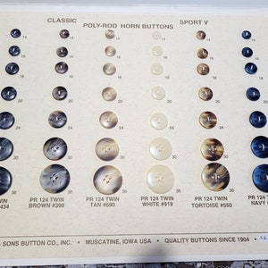 May include: A card with a variety of plastic buttons in different colors and sizes. The buttons are arranged in rows and columns, with each row representing a different size. The card also includes the text "Classic Poly-Rod Horn Buttons Sport V" and the text "PR 124 Twin" followed by the color and number of each button.