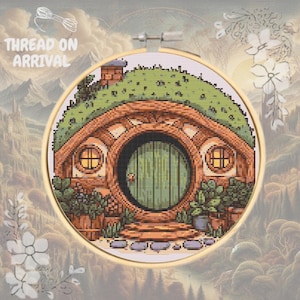 May include: A cross-stitch pattern of a hobbit house with a green door and a brown roof. The house is surrounded by green grass and flowers. The pattern is in a round embroidery hoop.