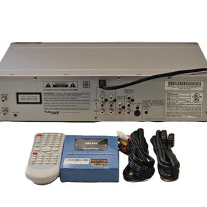 May include: Silver DVD player with a remote control, a blue box labelled "MINI AVERHDMI FULL HD 1080p", and various black and coloured cables. The DVD player has multiple input and output ports.