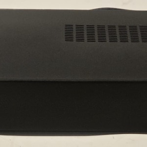 May include: A black OSD Audio digital amplifier with a rectangular design. The front panel features control knobs for balance and volume, along with power and speaker controls. A yellow caution sticker is visible on the top. The amplifier is designed for audio systems.