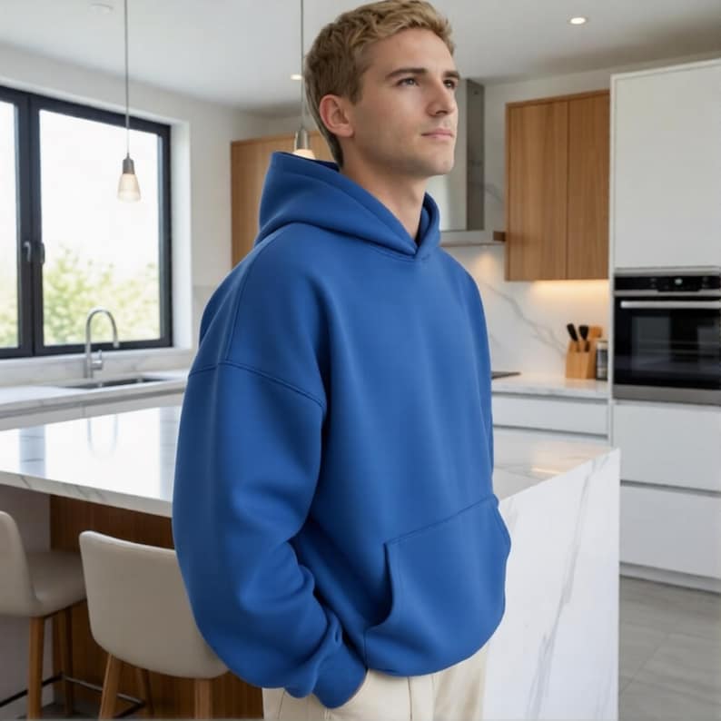May include: A solid blue hoodie with a kangaroo pocket. The hooded sweatshirt is made of a soft material and has a relaxed fit. The hoodie is a vibrant shade of blue and is suitable for casual wear.