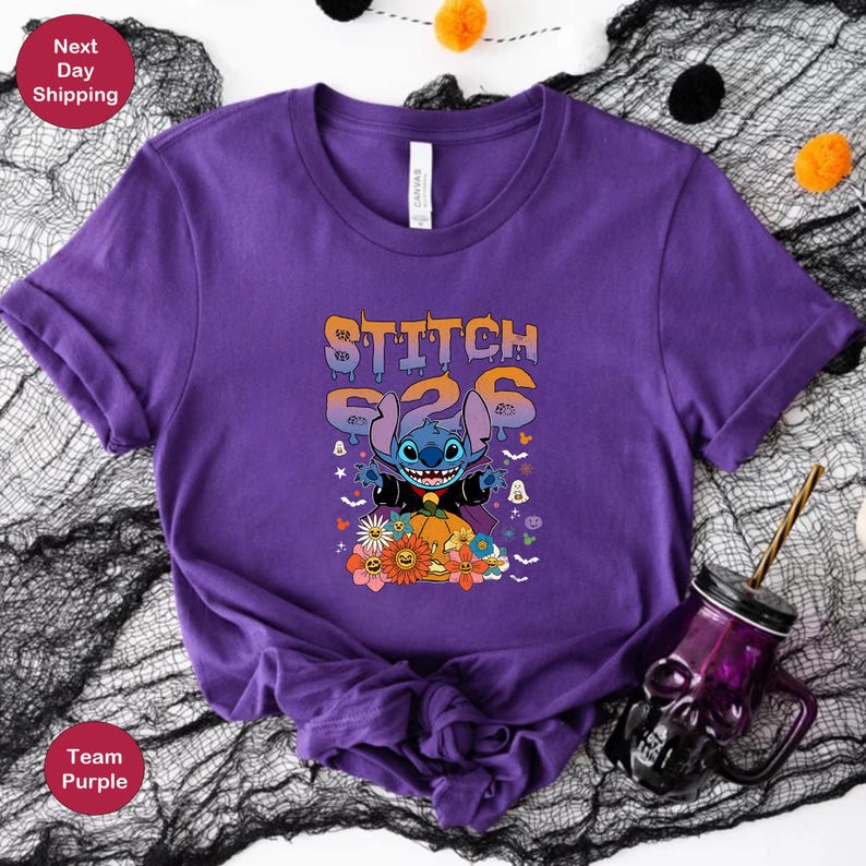 May include: Purple t-shirt with a blue Stitch character dressed as a vampire holding a pumpkin. The text "Stitch 626" is above the character in orange and yellow.