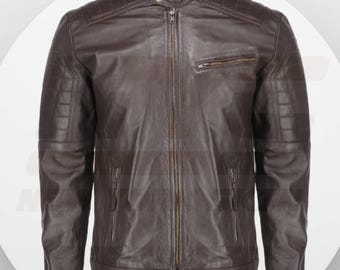 May include: A brown leather jacket with a zip fastening and multiple pockets. The jacket has a stand-up collar and a quilted design on the shoulders and sleeves.