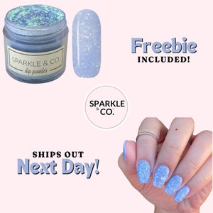May include: A jar of light blue glitter dip powder with the text "SPARKLE & CO. dip powder" on the label. A small sample of the dip powder is shown next to the jar. The image also shows a hand with light blue glitter nail polish and the text "Freebie INCLUDED!" and "SHIPS OUT Next Day!"