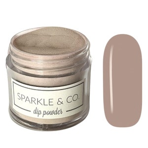 May include: A clear jar of light brown dip powder with the label "Sparkle & Co. dip powder". A sample of the powder is shown on a nail.