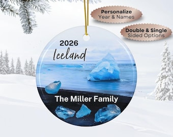 May include: A round ceramic ornament featuring a photographic print of blue icebergs on a black sand beach in Iceland. The text 2026, Iceland, and The Miller Family is printed on the surface. A gold string is attached for hanging purposes.