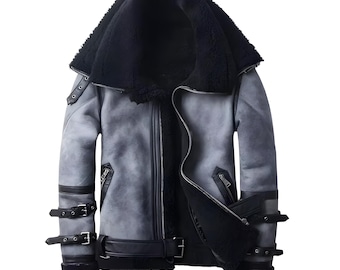 May include: A gray shearling jacket with a black shearling collar and black zipper closures. The jacket has a zippered pocket on the left side and a buckle closure at the waist.