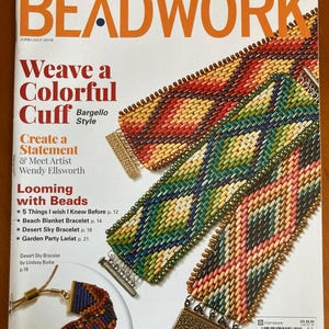 May include: A magazine cover for Beadwork, a publication for beading enthusiasts. The cover features a colorful beaded cuff bracelet with a Bargello style design. The magazine title is in large, bold orange letters. The cover also includes the text "Weave a Colorful Cuff" and "Looming with Beads".