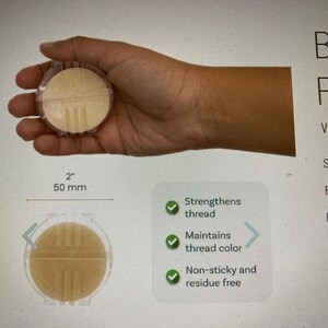 May include: A round, beige beeswax thread conditioner in a clear plastic case, measuring 2 inches or 50 mm in diameter. The product features text stating it strengthens thread, maintains thread color, and is non-sticky and residue free.