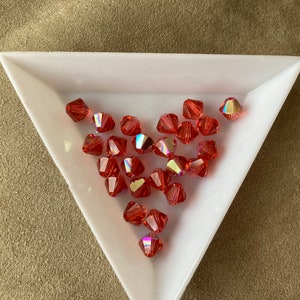 Swarovski 6mm Bicone, Padparadscha AB, package of 24, Article 5328 / 5301