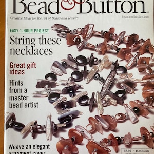 May include: A magazine cover for Bead & Button magazine, featuring a close-up of a variety of beads and jewelry. The cover text reads "String these necklaces" and "Great gift ideas".