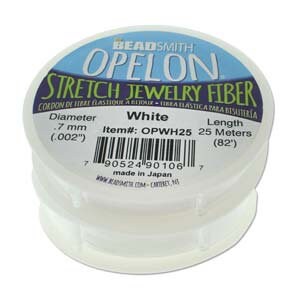 May include: White OPELON stretch jewelry fiber spool. The label indicates a diameter of .7 mm (.002") and a length of 25 meters (82"). The spool is made in Japan.