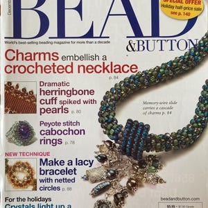 May include: A magazine cover for Bead & Button magazine, featuring a crocheted necklace with charms, a lacy bracelet with netted circles, and a snowflake ornament. The cover text reads "Charms embellish a crocheted necklace" and "Crystals light up a snowflake ornament".