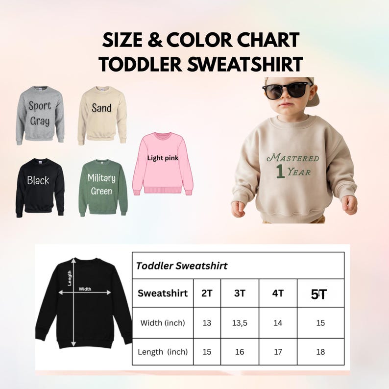 Op de afbeelding: Maat- en kleurenkaart voor peuter sweatshirts. De kaart toont sweatshirts in sportgrijs, zand, zwart, legergroen en lichtroze. Een kind draagt een zandkleurig sweatshirt met "MASTERED 1 YEAR" erop gedrukt. Afmetingen in inches.