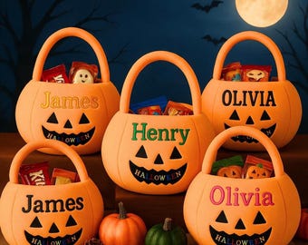 May include: Five orange pumpkin-shaped Halloween buckets with handles, each featuring a jack-o'-lantern face and the word Halloween printed below. The buckets are personalized with the names James, Henry, and Olivia in various colors.