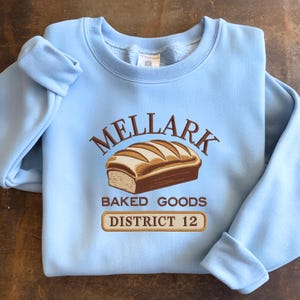 Embroidered Mellark Bakery Sweatshirt, District 12 Embroidered Shirt, Mellark Baked Goods Everdeen Apothecary Odair Fisherie Shirt