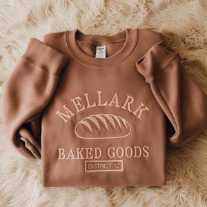 Embroidered Mellark Bakery Sweatshirt, District 12 Embroidered Shirt, Mellark Baked Goods Everdeen Apothecary Odair Fisherie Shirt