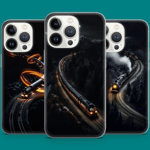 May include: Three phone cases with a dark, artistic design featuring trains on tracks winding through a mountainous landscape. The cases have a black background with glowing train lights and a teal background.