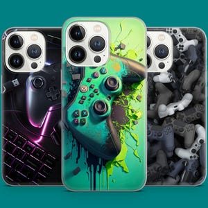 May include: Three phone cases with different designs. The first case has a black and white design with a video game controller. The second case has a green and black design with a video game controller. The third case has a black and white design with a pattern of video game controllers.
