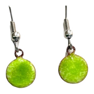 May include: A pair of small, round earrings with a bright lime green enamel finish. The earrings have silver-colored hooks and a simple, minimalist design. The circular pendants are approximately 0.5 inches in diameter.