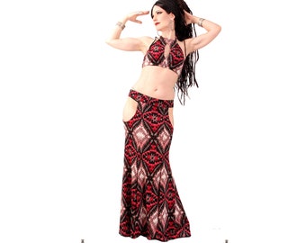 May include: A woman wearing a red and black patterned belly dancing costume with a halter top and a skirt with a high slit. The skirt has a geometric pattern with black, red, and white diamonds. The costume is from Dark Fusion Boutique, clothing by Lucretia'Renee Rathmann, Portland, Oregon.