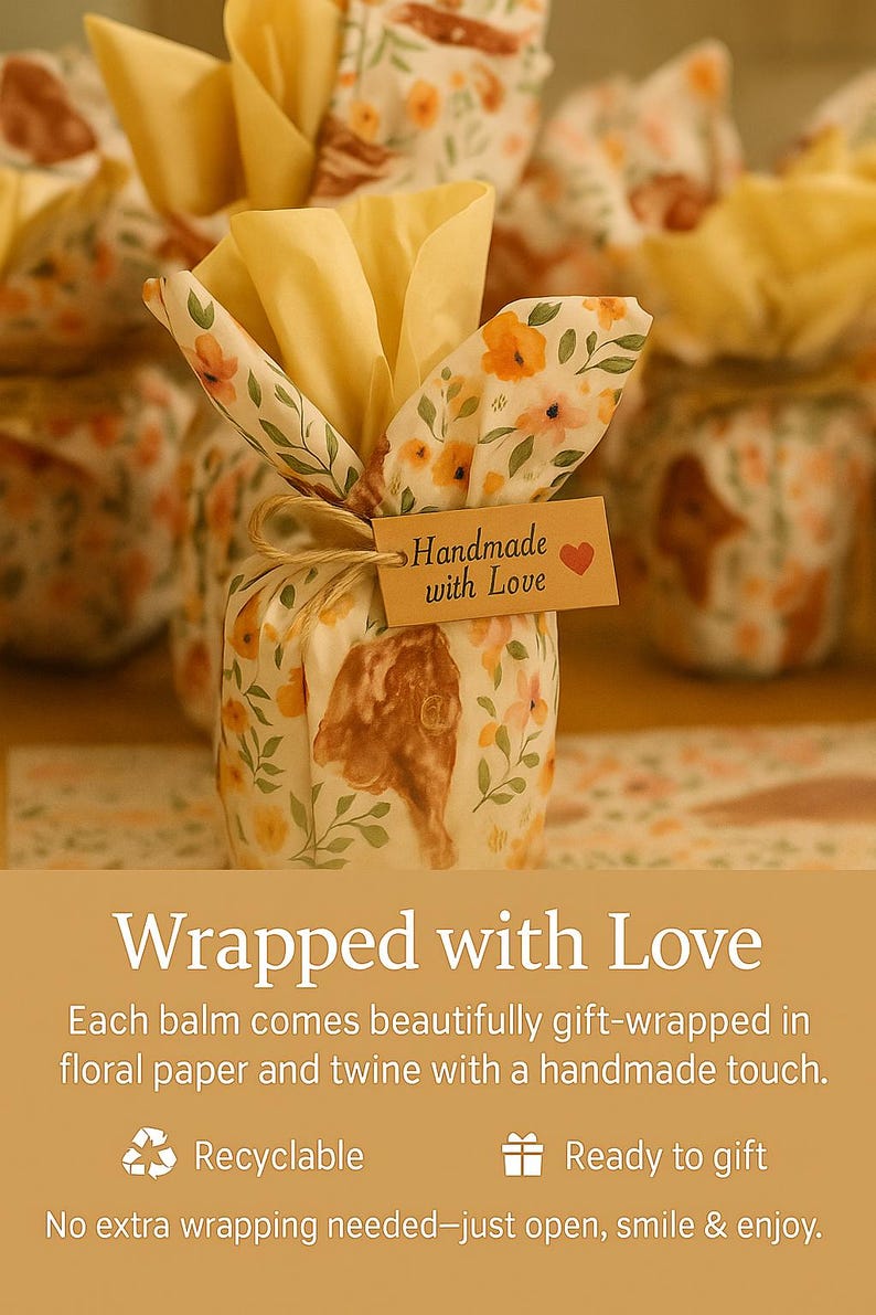 May include: A small item wrapped in cream-colored paper featuring a yellow and orange floral pattern, tied with brown twine. A rectangular tan tag attached to the twine displays the text Handmade with Love and a small red heart icon.