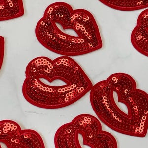 May include: Red sequin lip patches. These patches are perfect for adding a touch of sparkle to any project.