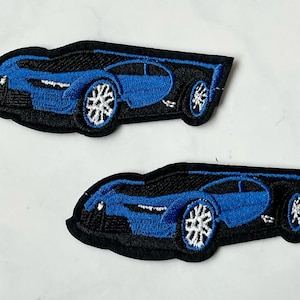 Puede incluir: Dos parches bordados de hierro azul y negro de un coche deportivo.