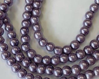 May include: A strand of lavender-colored pearl beads. The beads are round and have a smooth, glossy finish.