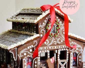 May include: A gingerbread barn structure decorated with white icing scrollwork, a red ribbon bow on the roof, and a wreath. The barn features a fenced front area, a horse figure, and a pink circular graphic with the text Recipes Included!.