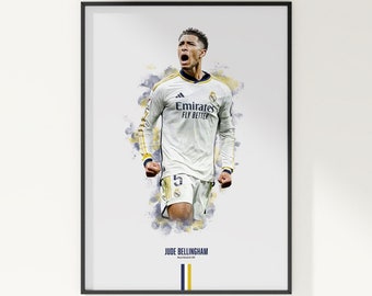 May include: Framed poster featuring a soccer player in a white jersey with the text "Emirates Fly Better." The player is set against a watercolor-style background with blue and yellow accents. The name "JUDE BELLINGHAM" is printed below.