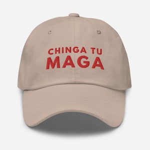May include: A beige baseball cap with the phrase "CHINGA TU MAGA" embroidered in red.