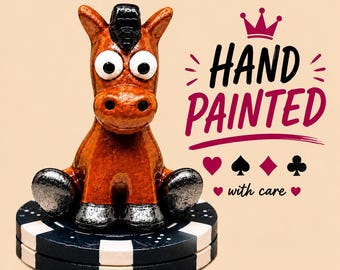 Könnte beinhalten: Eine braune Pferdefigur mit großen weißen Augen und schwarzen Hufen, die auf einem schwarz-weißen Pokerchip sitzt. Der Text lautet HAND PAINTED mit einer Kronenikone darüber und Kartensymbolen darunter, gefolgt von dem kursiven Text with care.