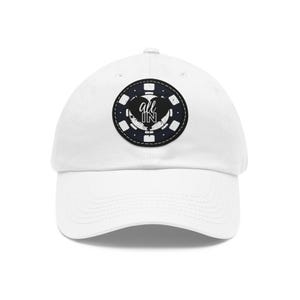 May include: White baseball cap with a black and white poker chip design. The chip features the words "all in" in a stylized font. The cap has a curved brim and an adjustable strap.