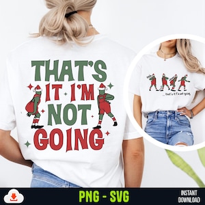 Puede incluir: Una camiseta blanca con un diseño gráfico verde y rojo que dice "That's it I'm not going". El gráfico presenta un personaje de dibujos animados con un gorro de Papá Noel y llevando una bolsa.